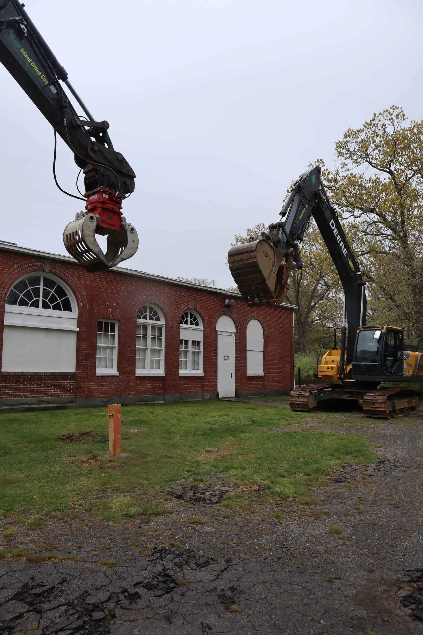 Green Island Group Corp excavator removing tree stump during land clearing and site preparation