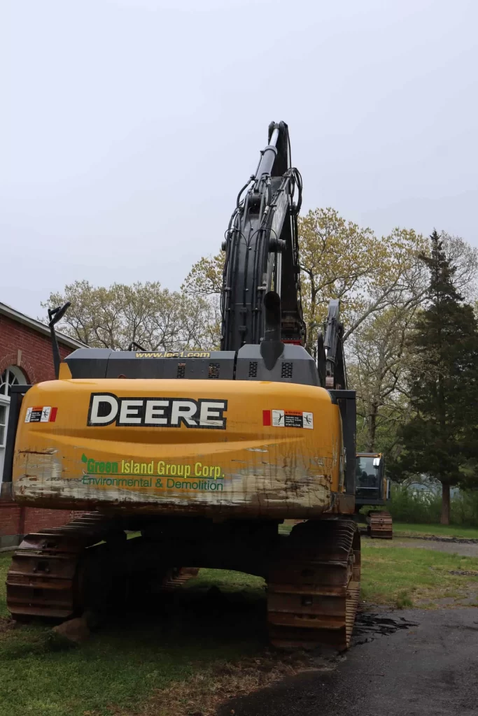 Green Island Group Corp excavator used for demolition, excavation, and site preparation services