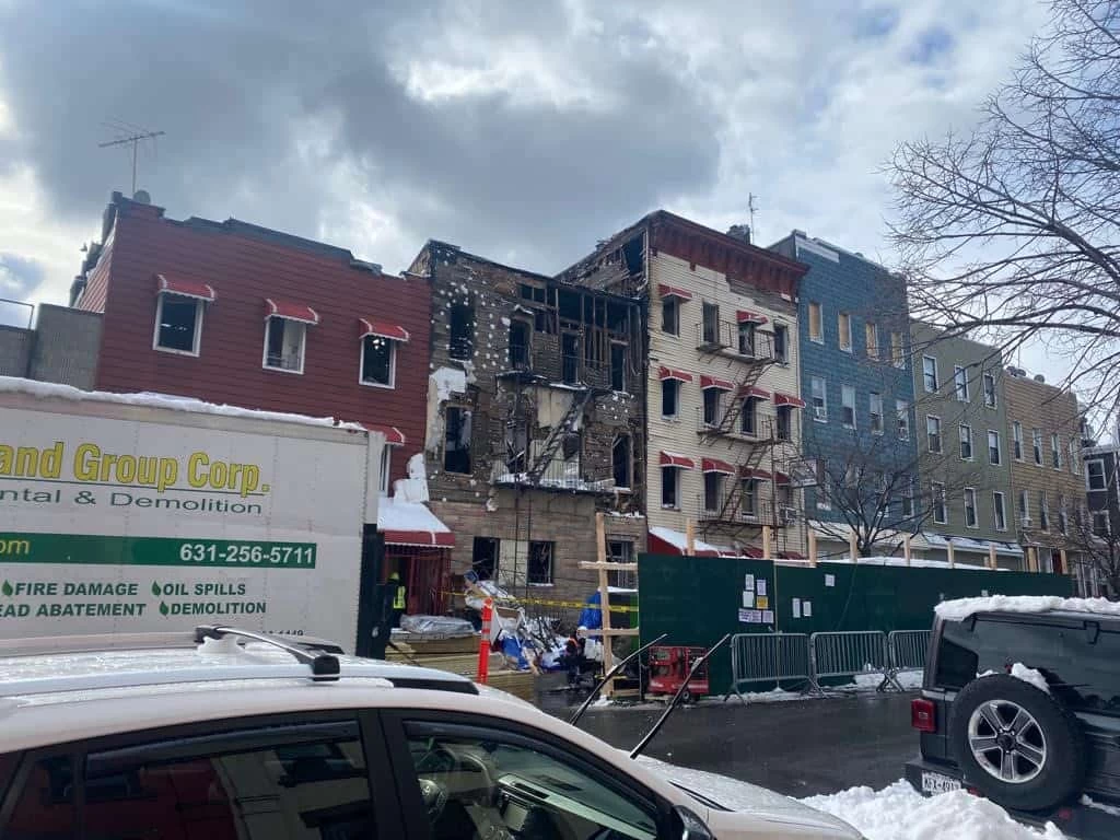 Green Island Group Corp experts and service van at fire-damaged apartment providing restoration services