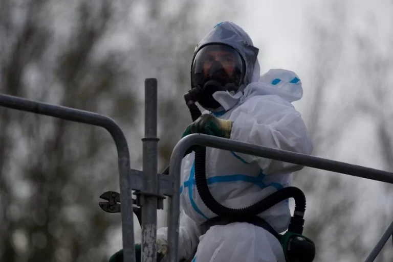 Workers removing asbestos materials from the exterior of a rural school building in Hauts-de-France, France.