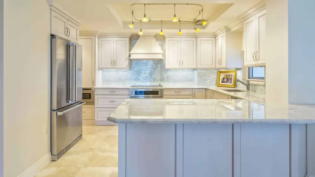 Modern kitchen featuring white cabinetry and a stainless steel refrigerator.